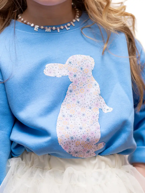 Toddler girl wearing blue Easter bunny sweatshirt, spring photo outfit idea for kids